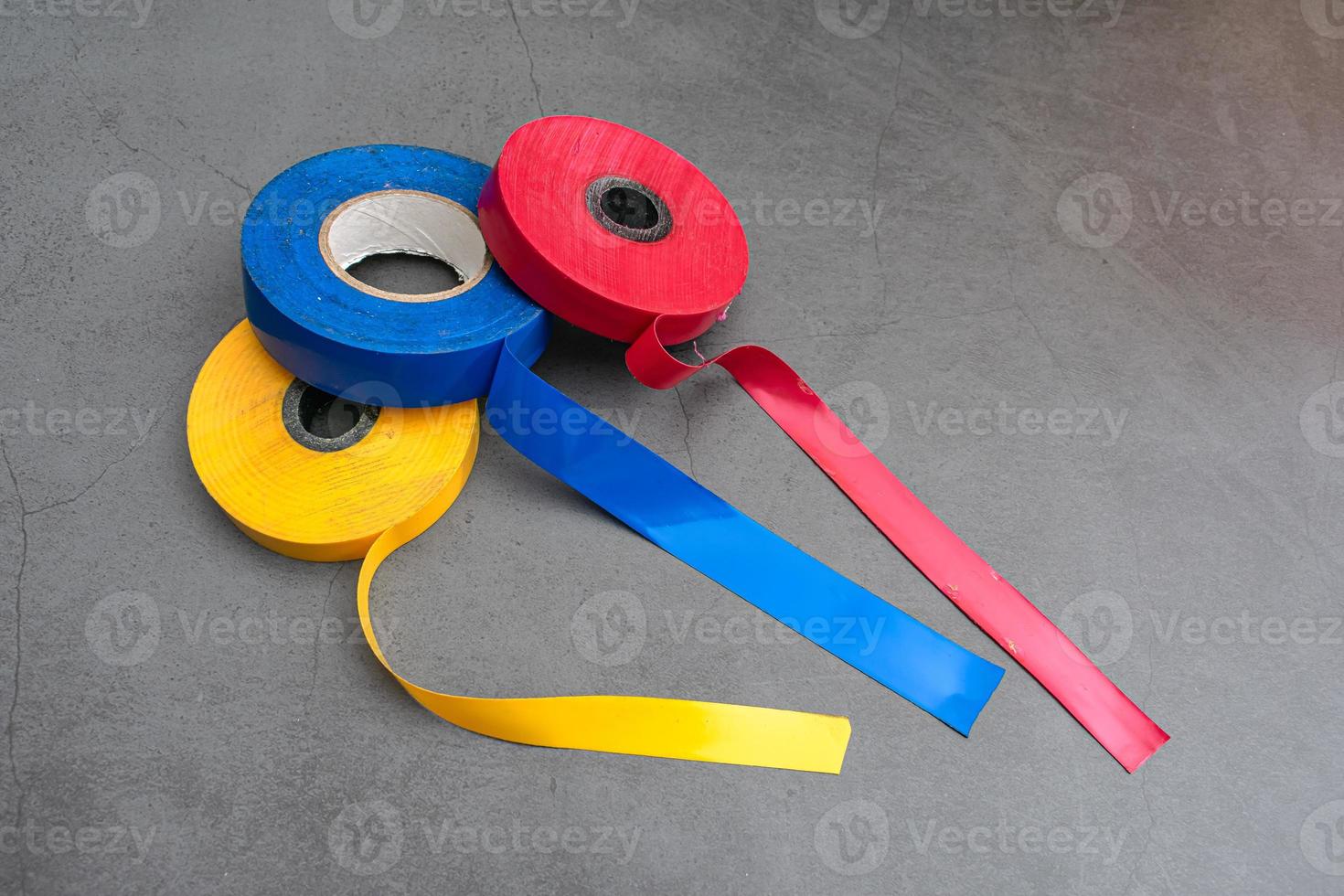 Three rolls of electrical tape of different colors for repair and gluing photo