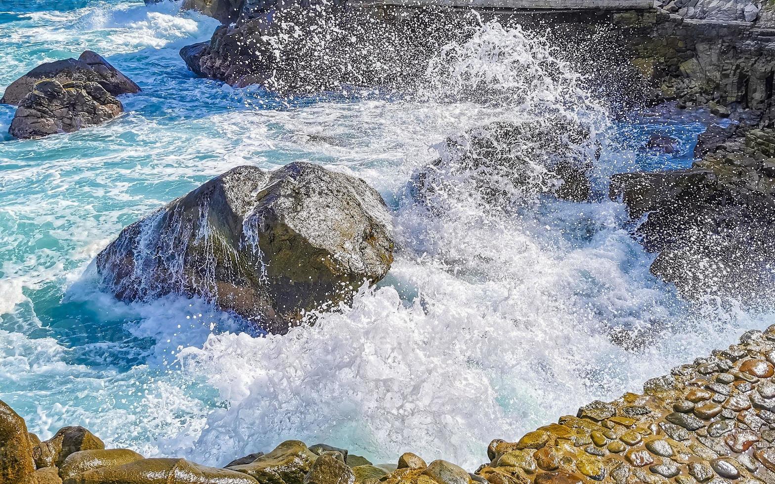 Beautiful surfer waves rocks cliffs at beach Puerto Escondido Mexico. photo