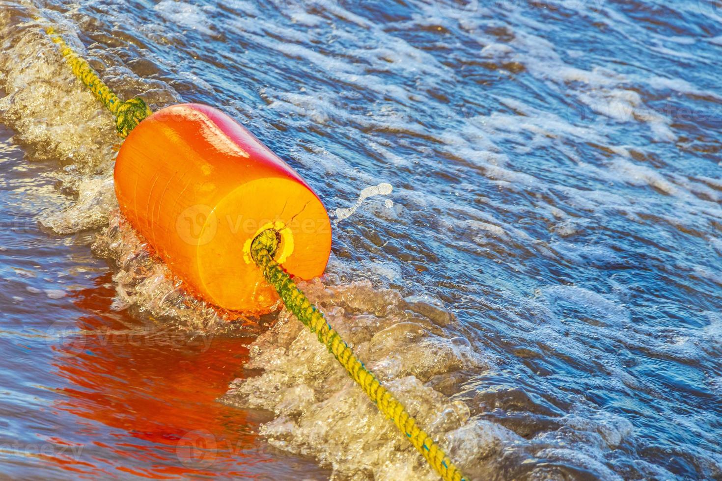 Blue water waves and ocean with buoy and ropes Mexico. photo