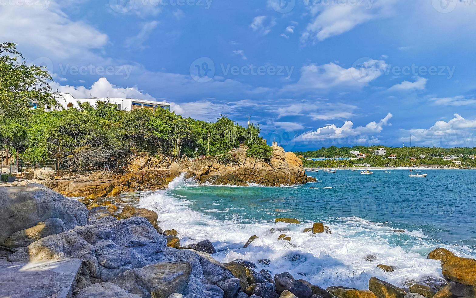 Beautiful surfer waves rocks cliffs at beach Puerto Escondido Mexico. photo