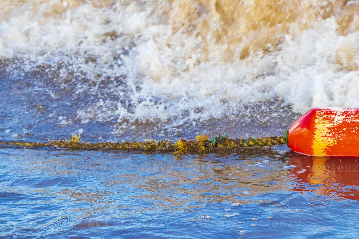 Blue water waves and ocean with buoy and ropes Mexico. photo