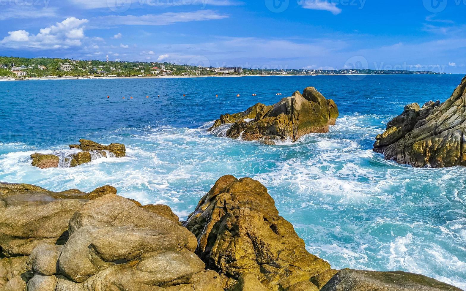 Beautiful surfer waves rocks cliffs at beach Puerto Escondido Mexico. photo