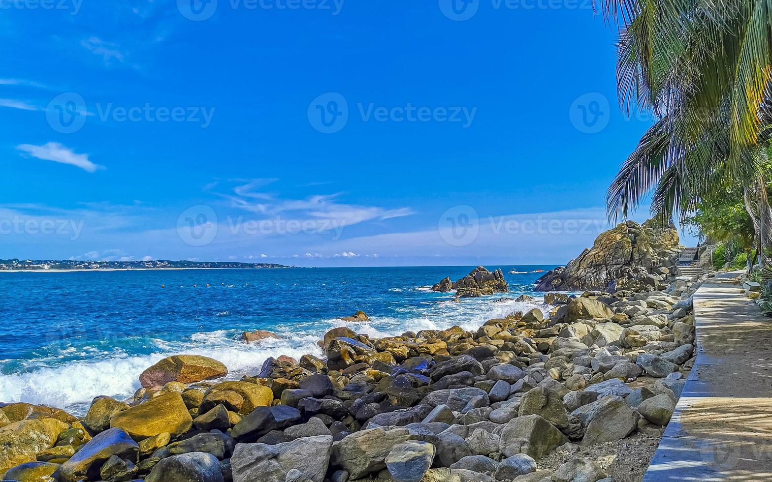 Beautiful surfer waves rocks cliffs at beach Puerto Escondido Mexico. photo