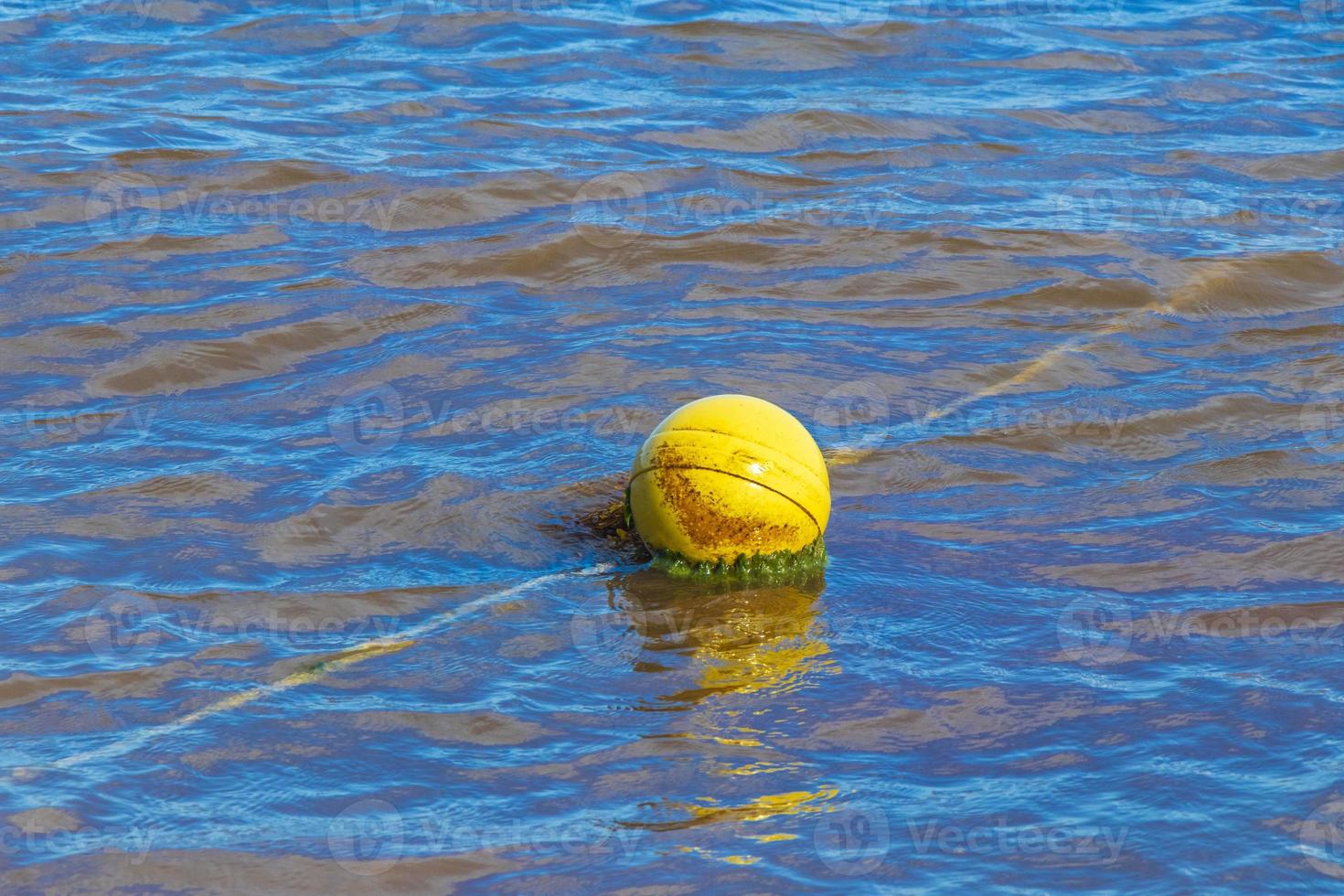 Blue water waves and ocean with buoy and ropes Mexico. photo