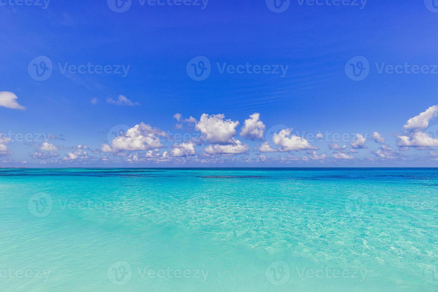 Bright beautiful seascape, sandy beach, clouds reflected in the water, natural minimalistic background and texture, panoramic view banner. Sea ocean ecology nature concept. Blue sky clouds, idyllic photo