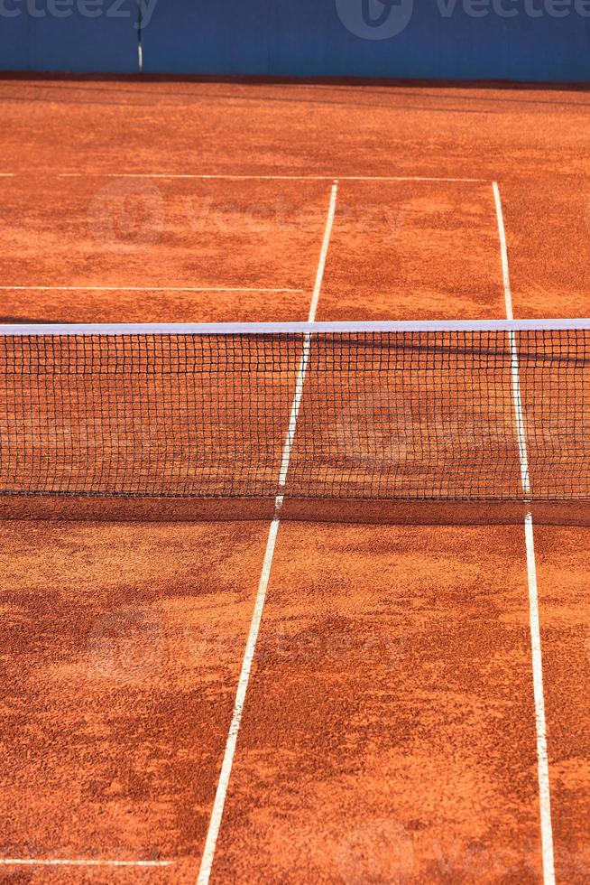 Empty Clay Tennis Court and Net photo