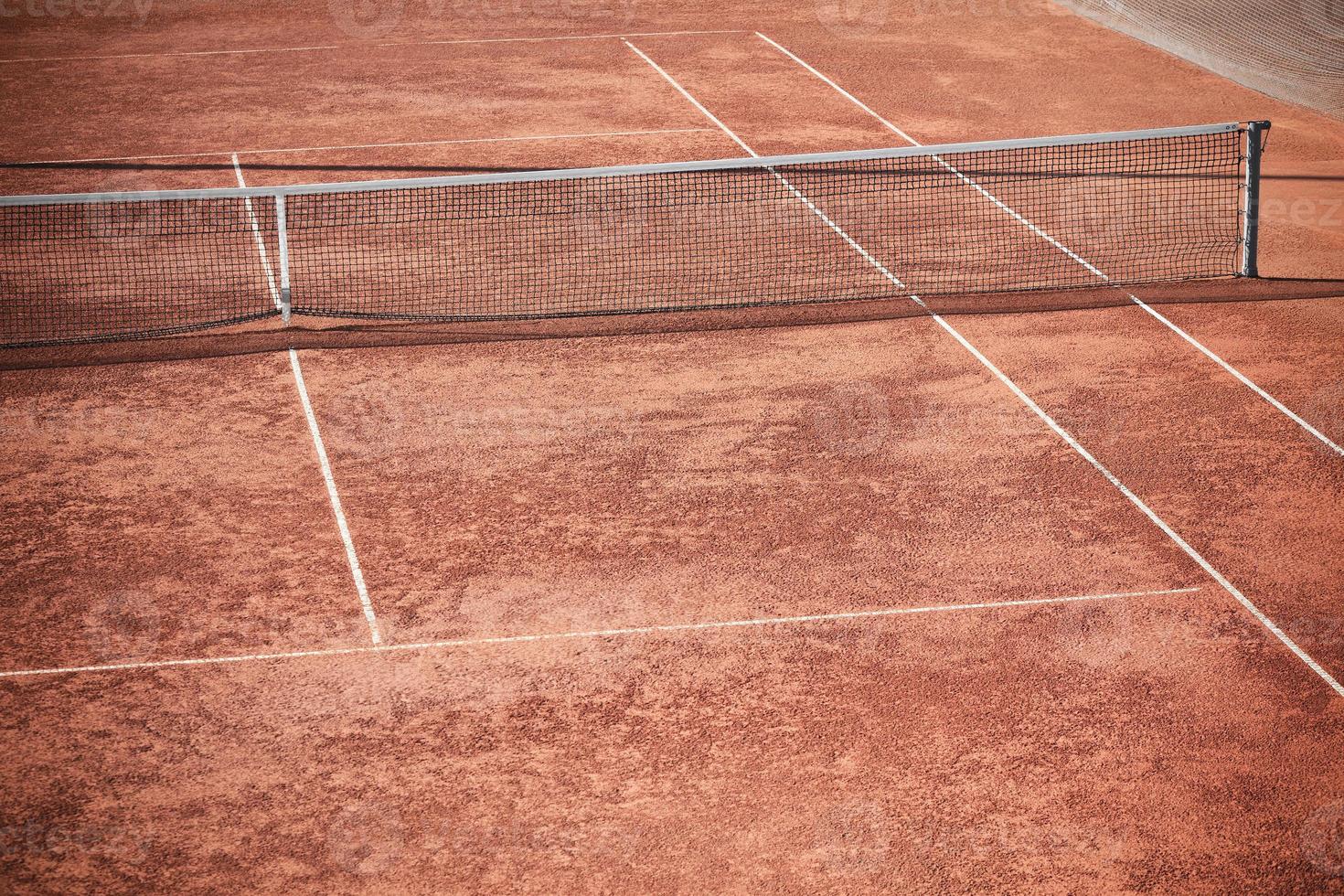 Empty Clay Tennis Court and Net photo