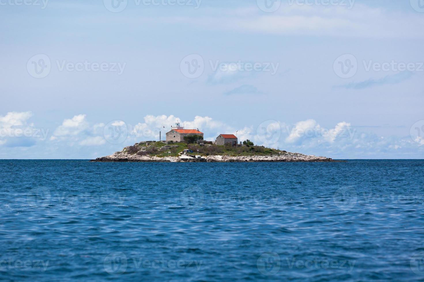 Lighthouse on a Small Island in the Adriatic Sea photo