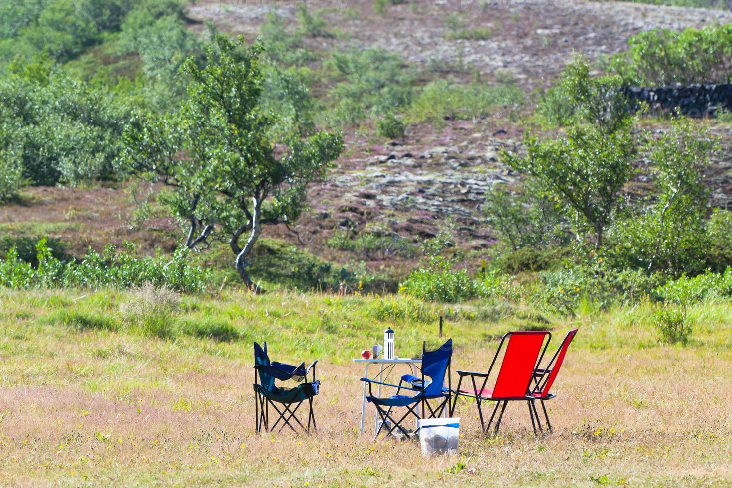 Camping site with camp-chairs and table photo