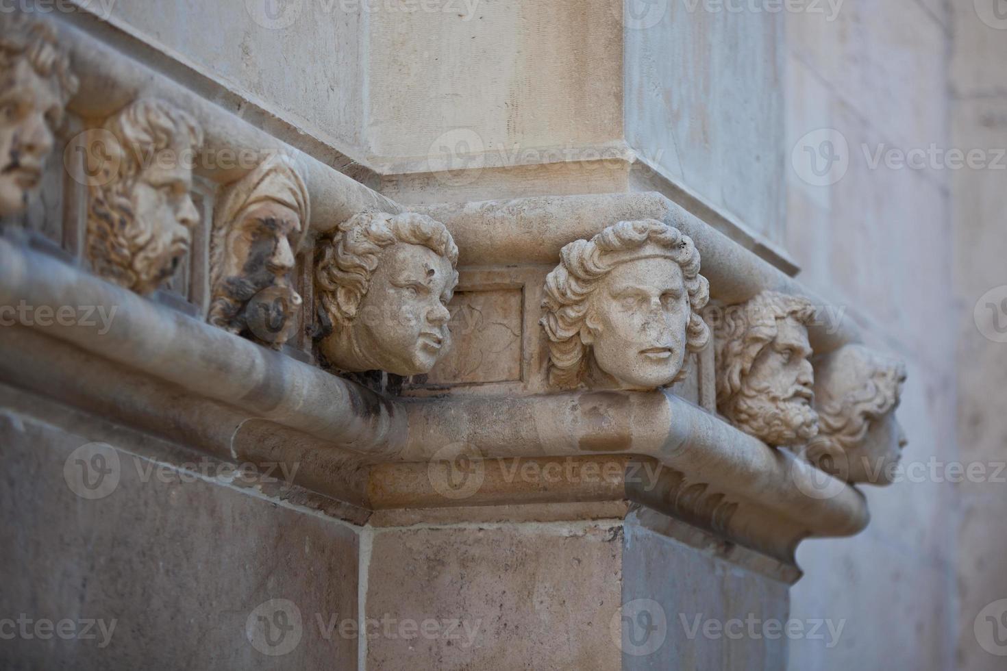 Stone heads at Cathedral of St. James in Sibenik, Croatia photo