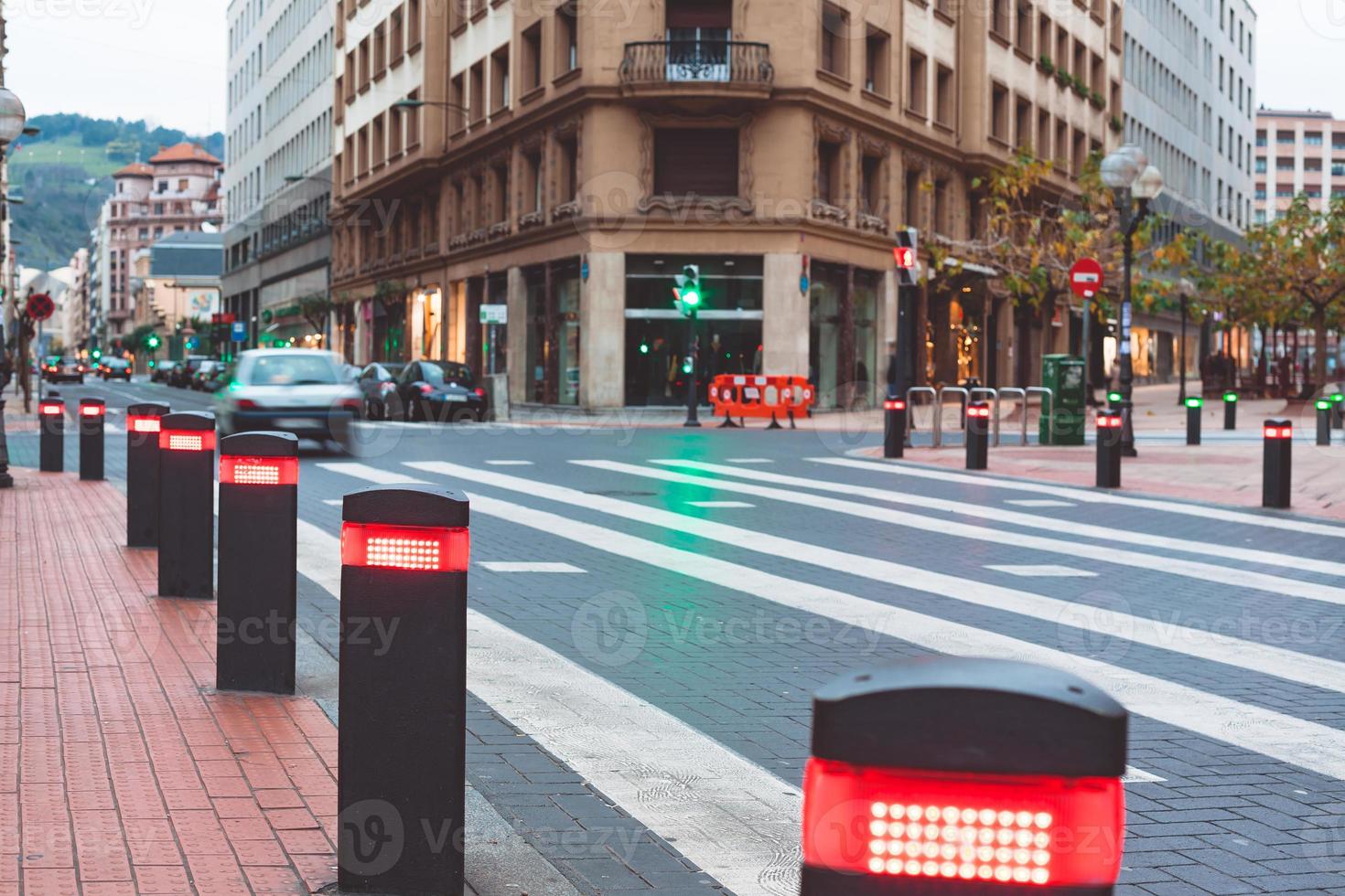 Modern traffic lights posts on pedestrian crossing photo