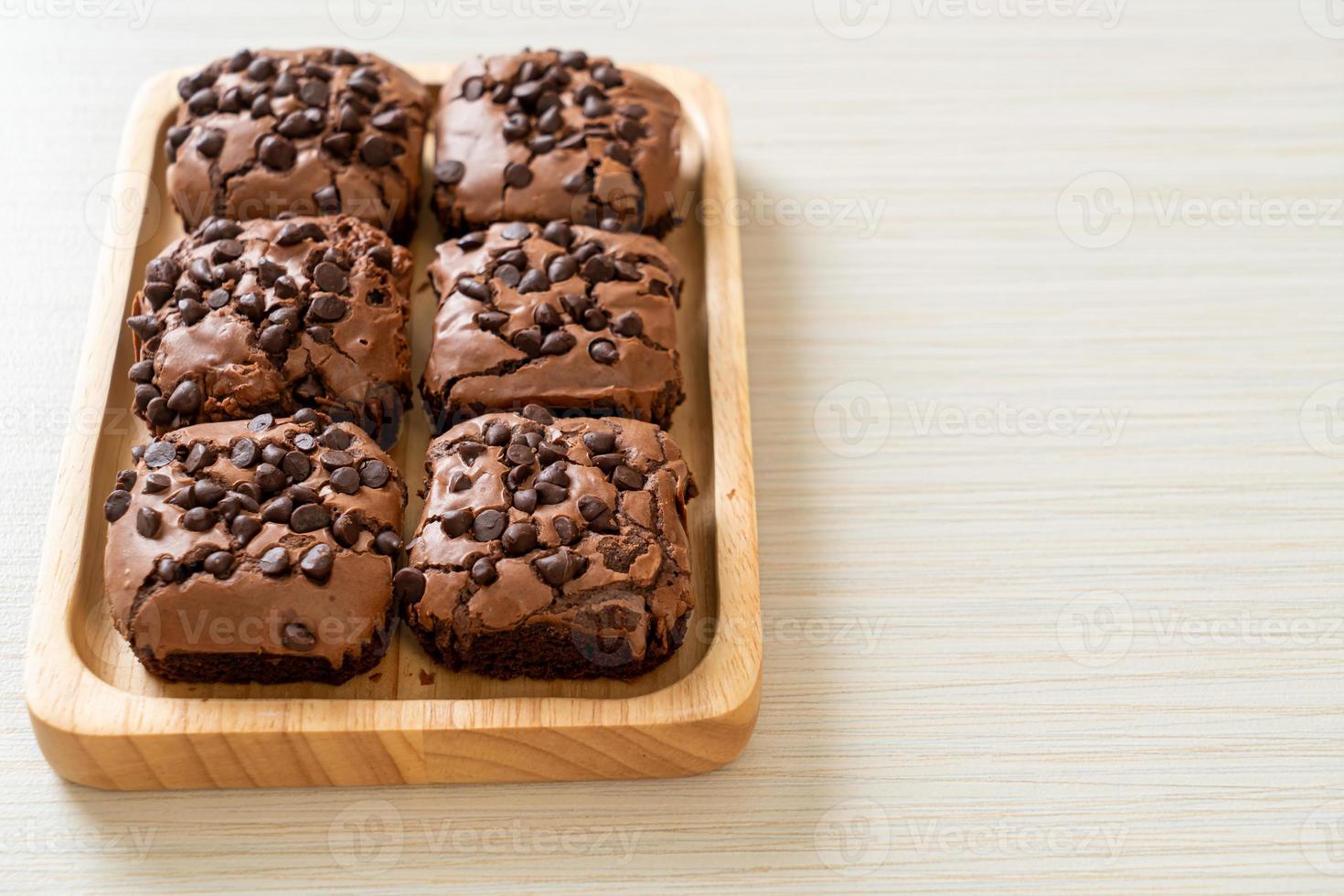 dark chocolate brownies topped by chocolate chips photo