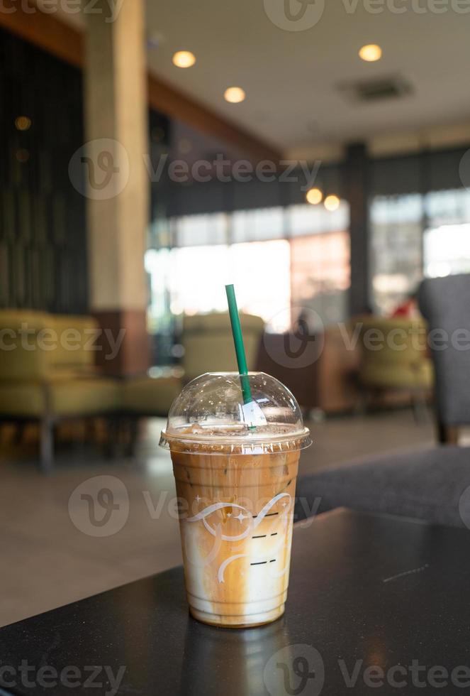 caramel macchiato coffee cup in coffee shop photo