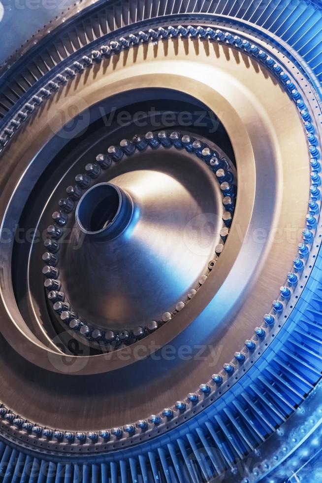 The rotor disk with the blades of a turbojet gas turbine engine with a blue glow. photo