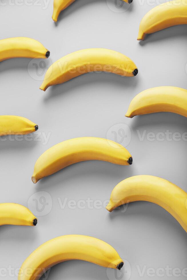 Bright pattern of yellow bananas on a gray background fashionable