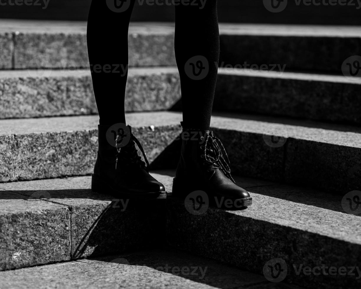 Woman legs in black ankle boots photo