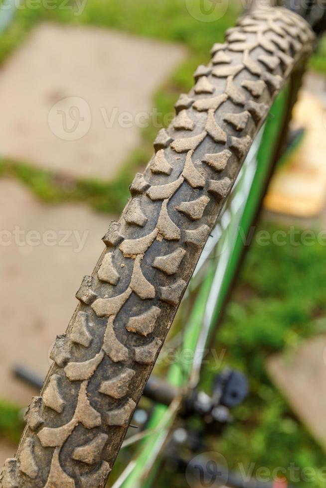 Bike waiting mechanic for repair in bicycle repair shop, outdoor. Bicycle wheel close up ready for examines, fixes modern cycle transmission system. Bike maintenance, sport shop concept. photo