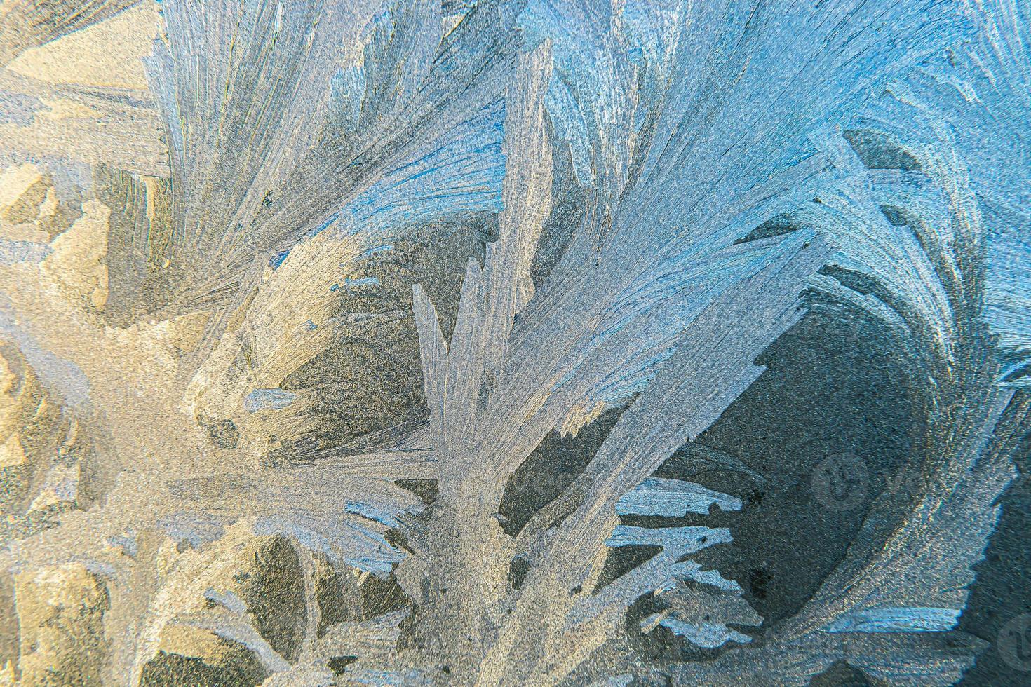 Frozen winter window with shiny ice frost pattern texture. Christmas wonder symbol, abstract background. Extreme north low temperature, natural Ice snow on frosty glass, cool winter weather outdoor. photo
