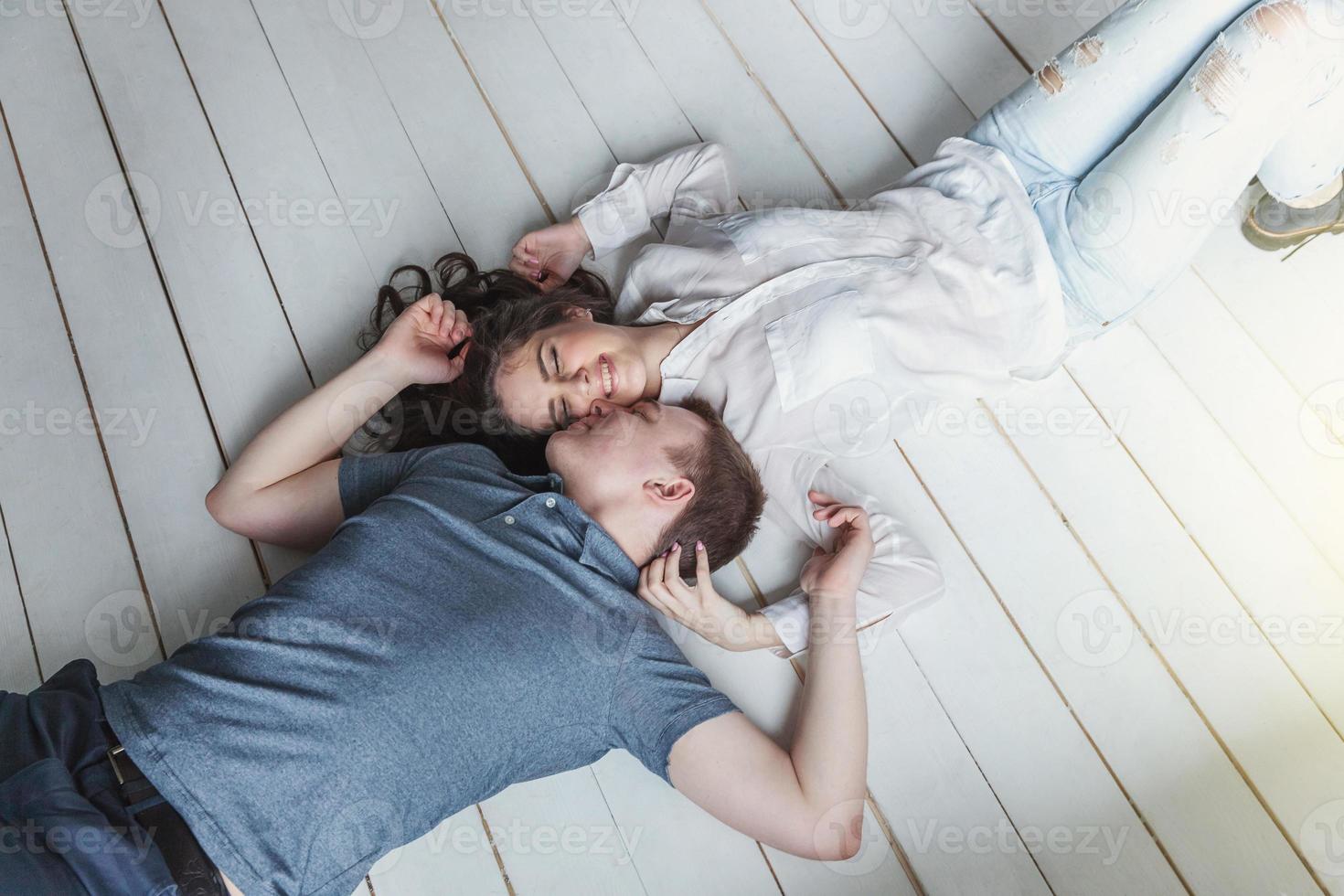 Romantic sexy couple in love having nice time together. Young woman hugging boyfriend, white background photo