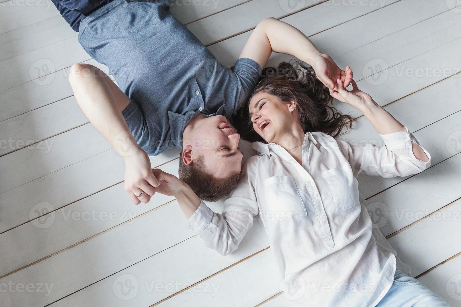 Romantic sexy couple in love having nice time together. Young woman hugging boyfriend, white background photo