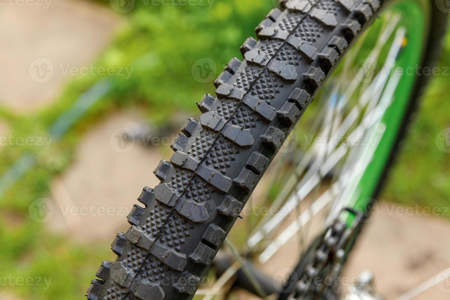 Bike waiting mechanic for repair in bicycle repair shop, outdoor. Bicycle wheel close up ready for examines, fixes modern cycle transmission system. Bike maintenance, sport shop concept. photo