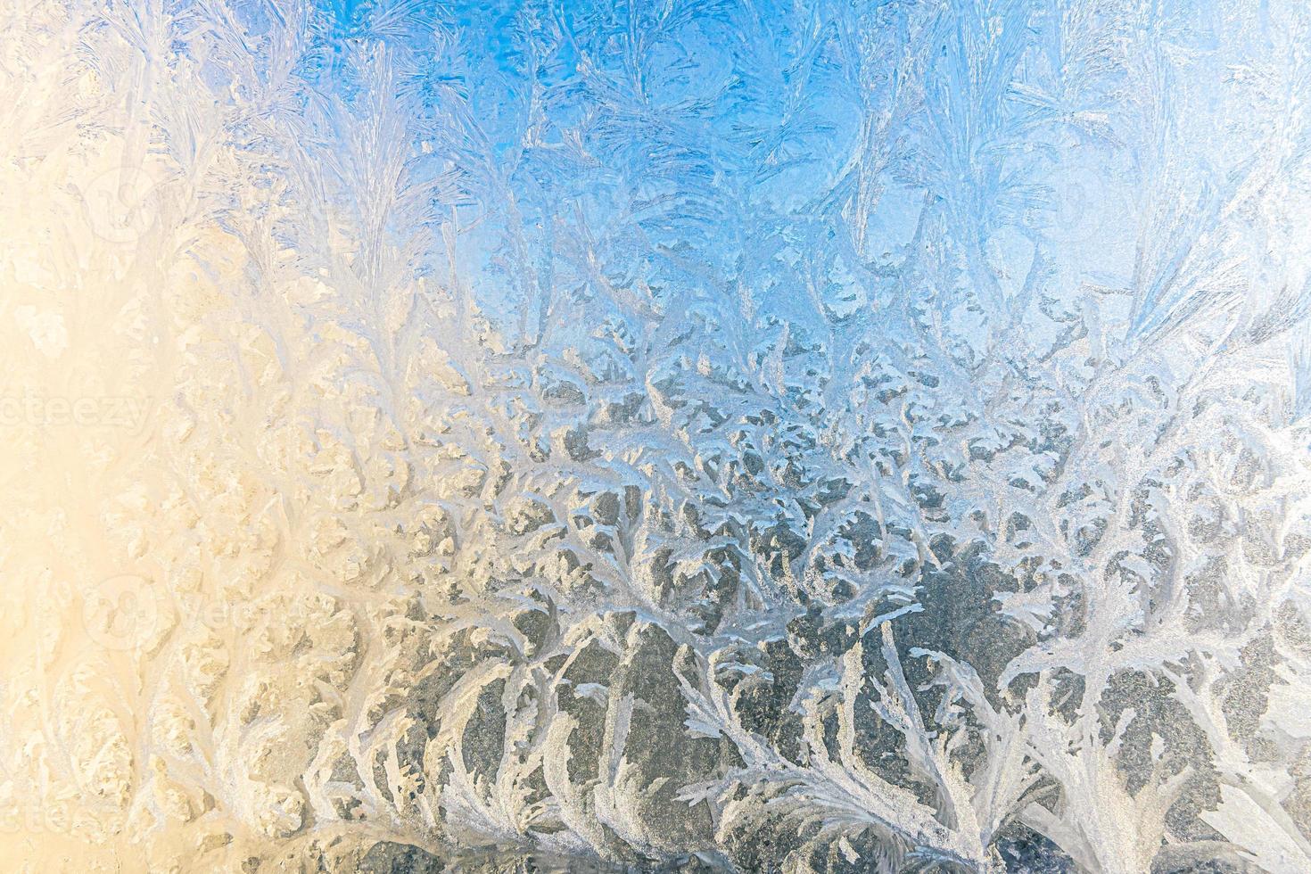 Frozen winter window with shiny ice frost pattern texture. Christmas wonder symbol, abstract background. Extreme north low temperature, natural Ice snow on frosty glass, cool winter weather outdoor. photo