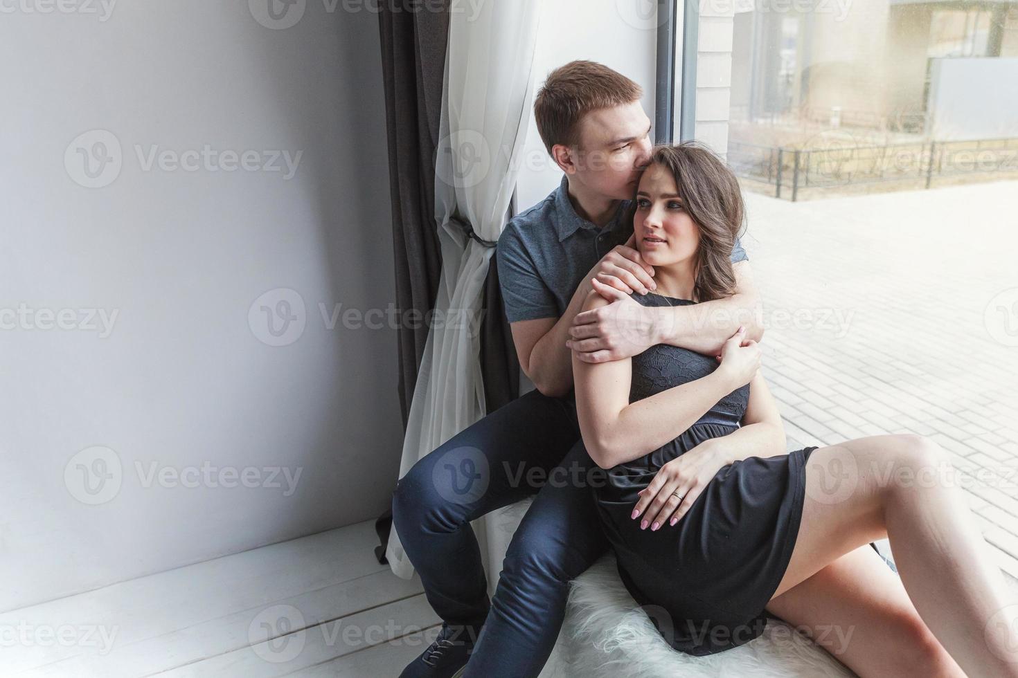 Romantic sexy couple in love having nice time together. Young woman hugging boyfriend, white background photo