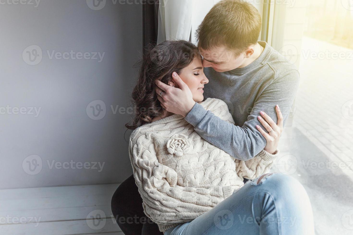 Romantic sexy couple in love having nice time together. Young woman hugging boyfriend, white background photo