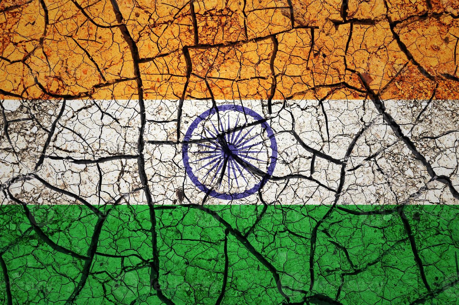 Dry soil pattern on the flag of India. Country with drought concept. Water problem. Dry cracked earth country. photo