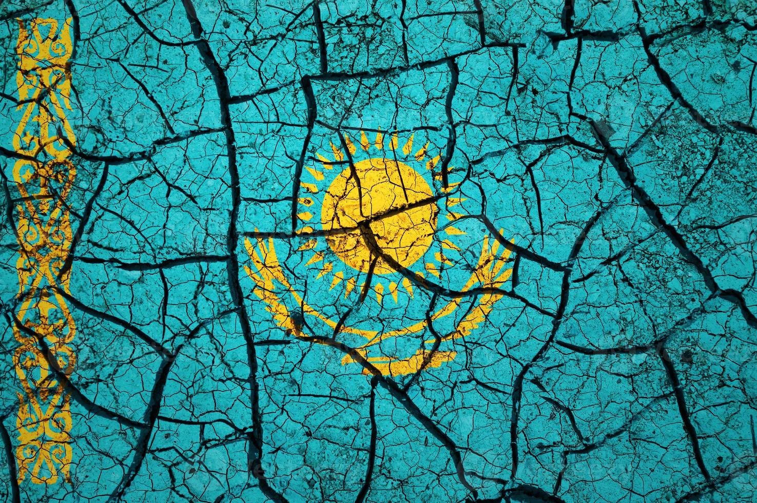 Dry soil pattern on the flag of Kazakhstan. Country with drought concept. Water problem. Dry cracked earth country. photo