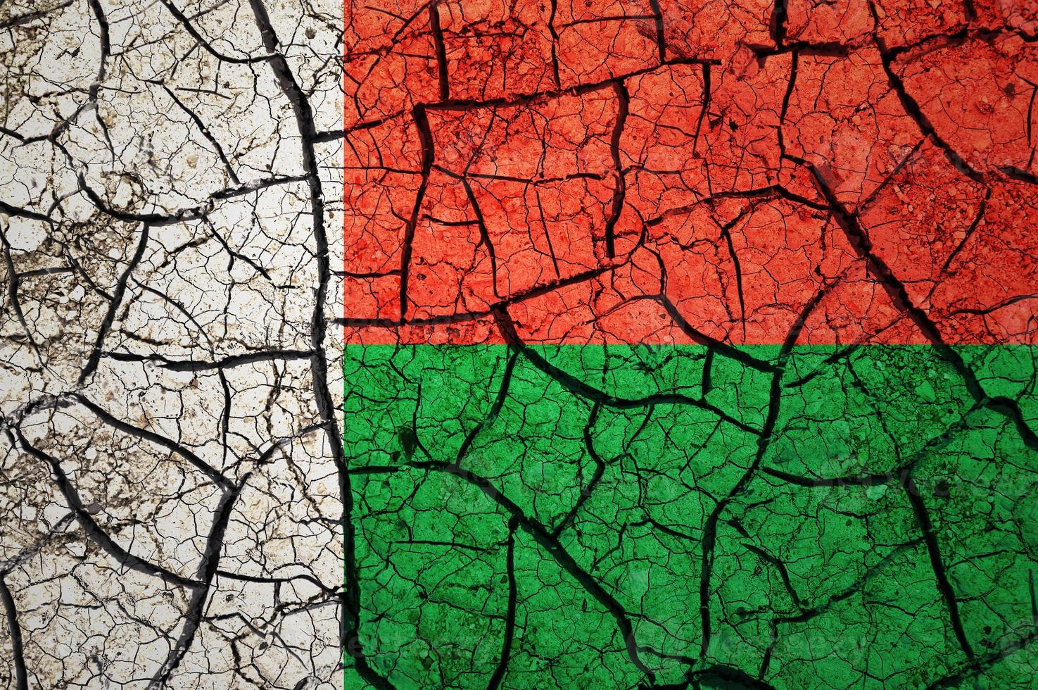 Dry soil pattern on the flag of Madagascar. Country with drought concept. Water problem. Dry cracked earth country. photo