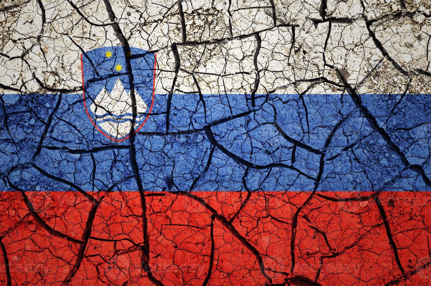 Dry soil pattern on the flag of Slovenia. Country with drought concept. Water problem. Dry cracked earth country. photo