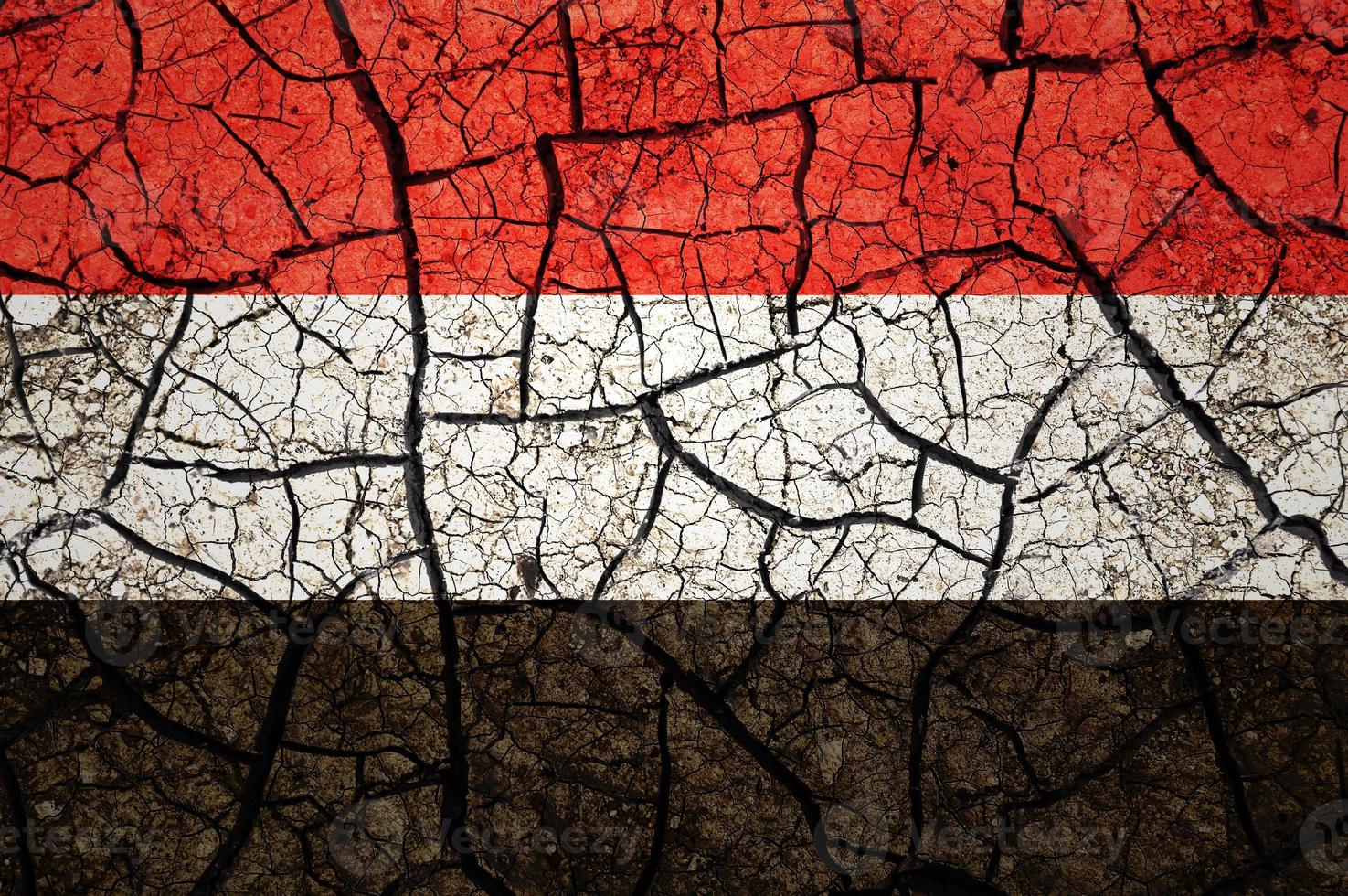 Dry soil pattern on the flag of Yemen. Country with drought concept. Water problem. Dry cracked earth country. photo