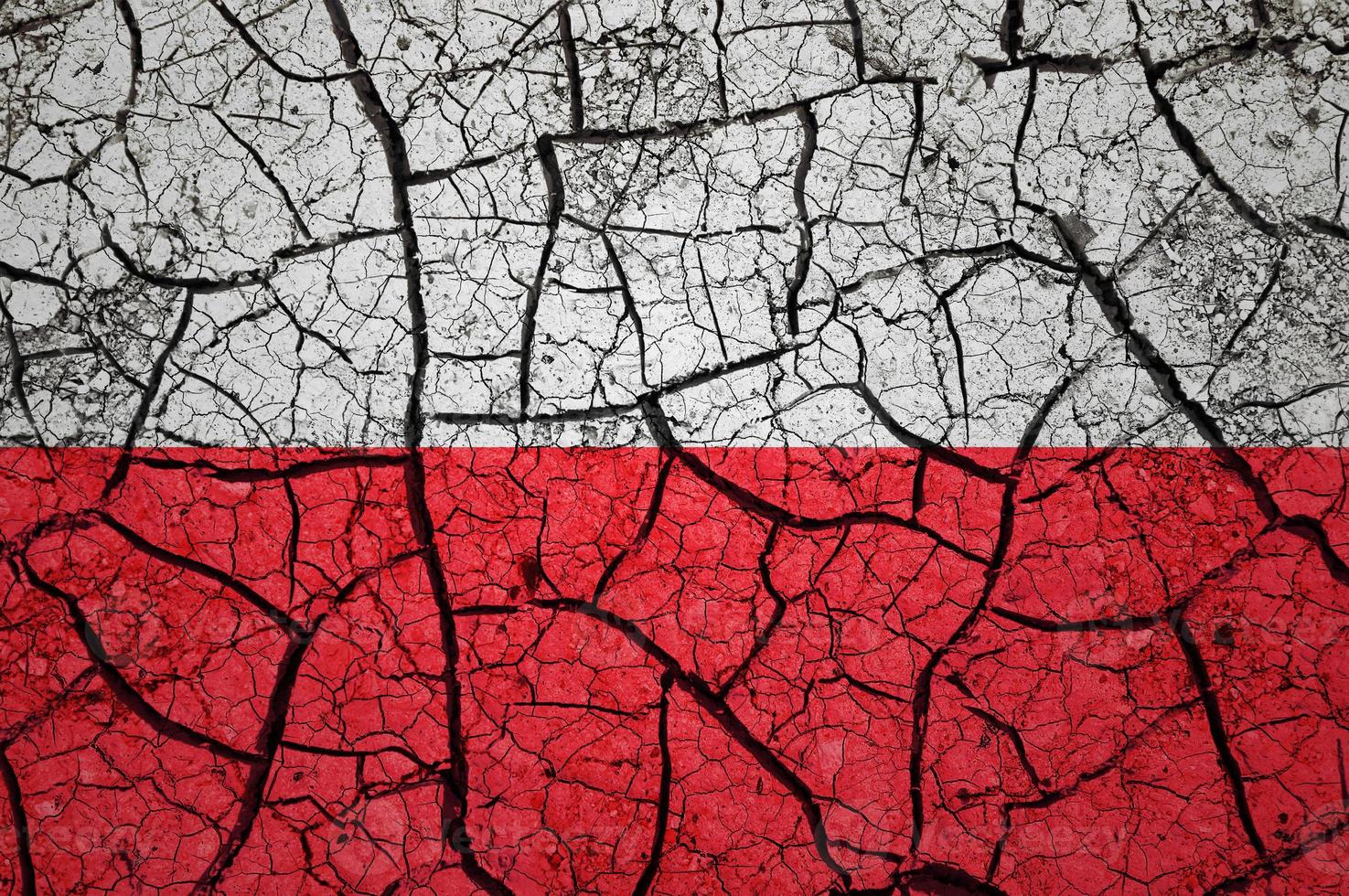 Dry soil pattern on the flag of Poland. Country with drought concept. Water problem. Dry cracked earth country. photo