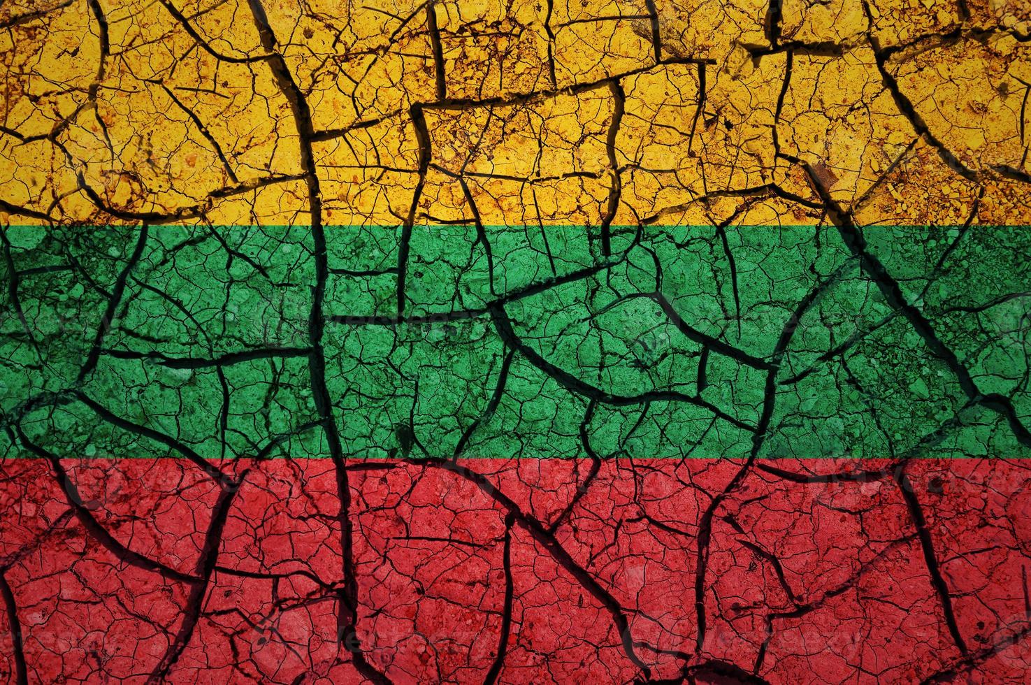 Dry soil pattern on the flag of Lithuania. Country with drought concept. Water problem. Dry cracked earth country. photo
