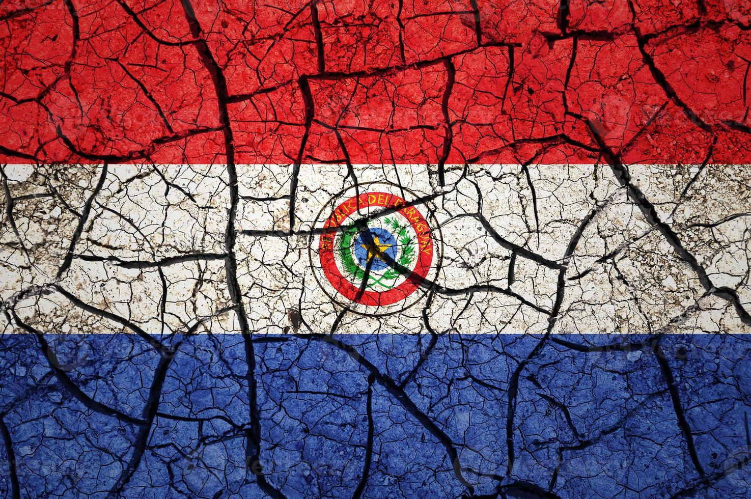 Dry soil pattern on the flag of Paraguay. Country with drought concept. Water problem. Dry cracked earth country. photo