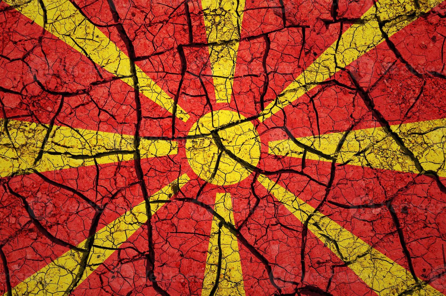 Dry soil pattern on the flag of Macedonia. Country with drought concept. Water problem. Dry cracked earth country. photo