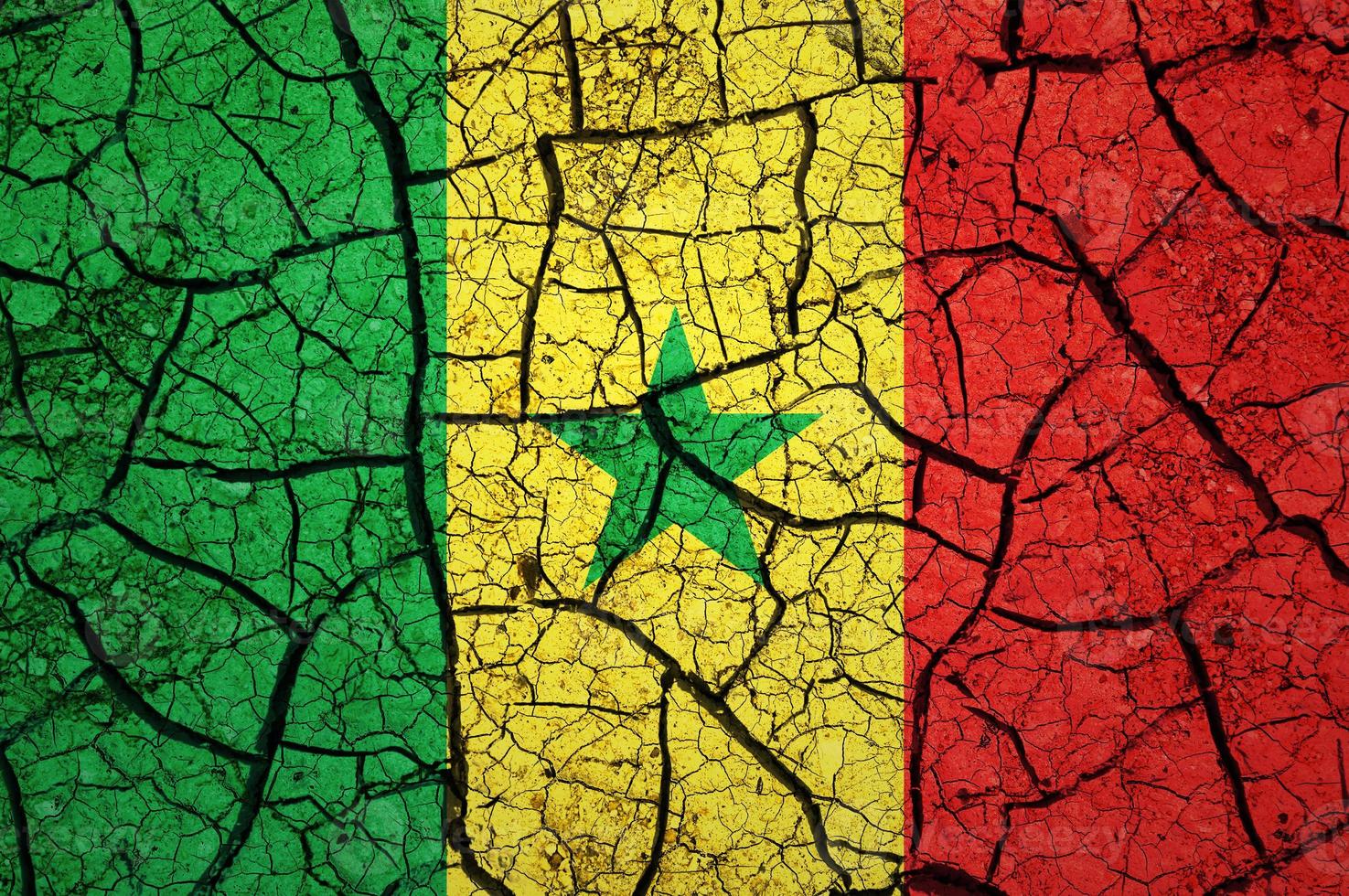 Dry soil pattern on the flag of Senegal. Country with drought concept. Water problem. Dry cracked earth country. photo