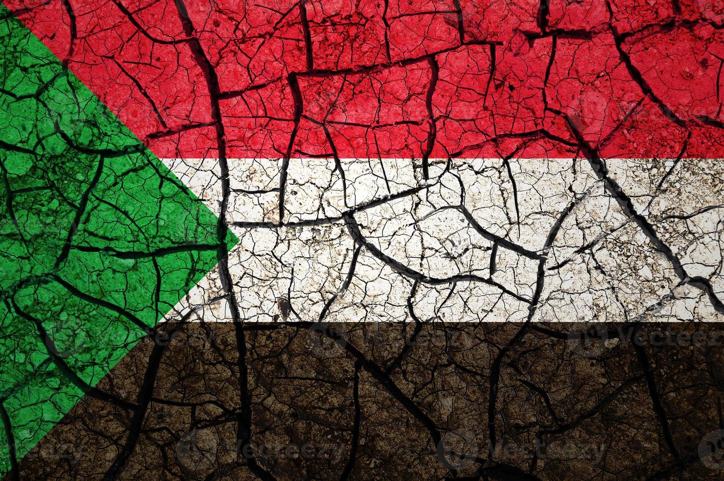 Dry soil pattern on the flag of Sudan. Country with drought concept. Water problem. Dry cracked earth country. photo