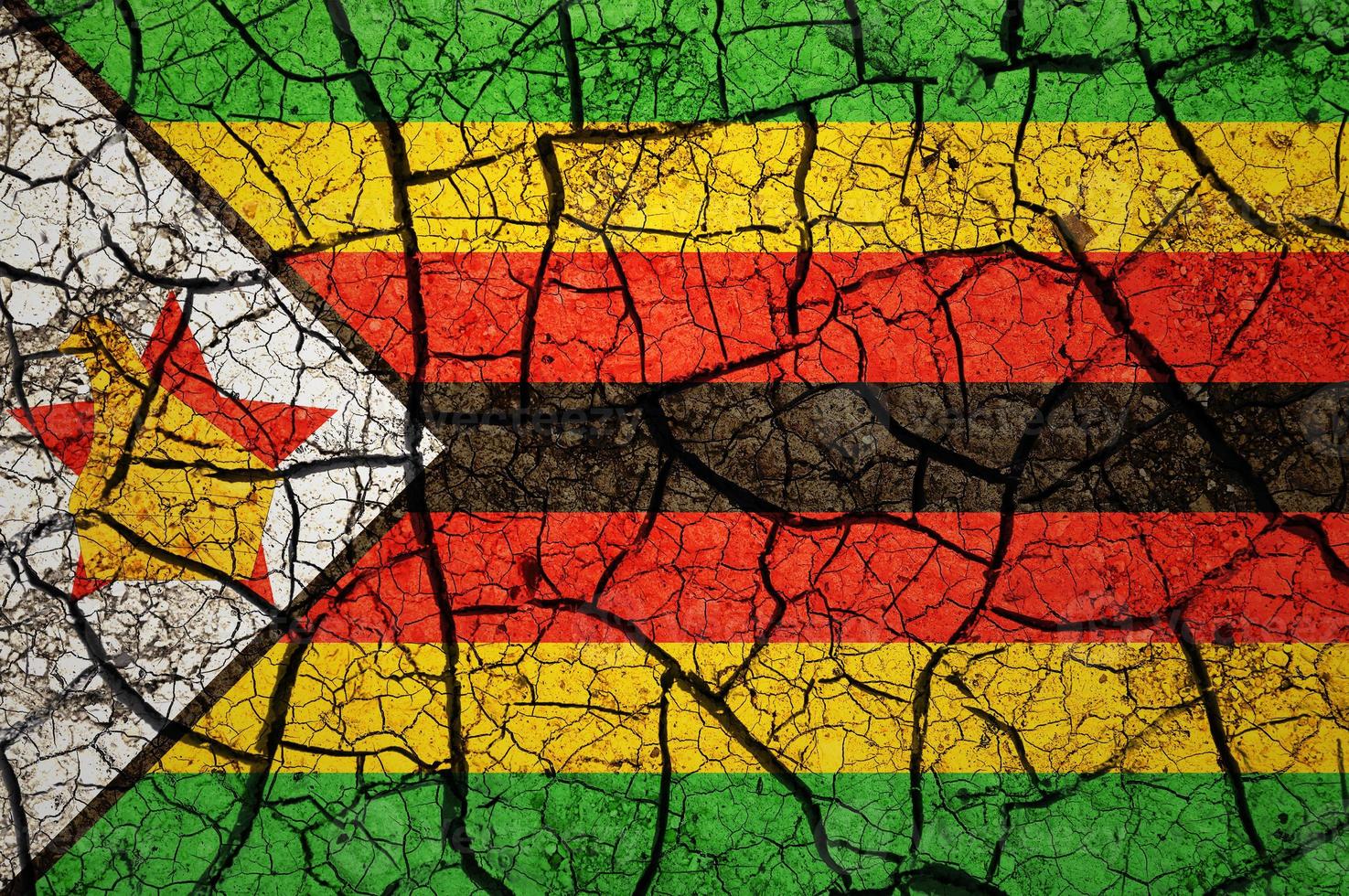 Dry soil pattern on the flag of Zimbabwe. Country with drought concept. Water problem. Dry cracked earth country. photo