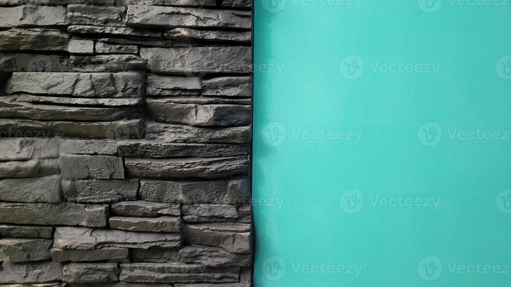 Turquoise wall and black brickwork for background or texture photo