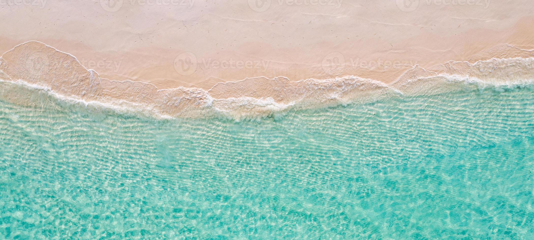 Relaxing aerial beach scene, summer vacation holiday template banner. Waves surf with amazing blue ocean lagoon, sea shore, coastline. Perfect aerial drone top view. Peaceful bright beach, seaside photo