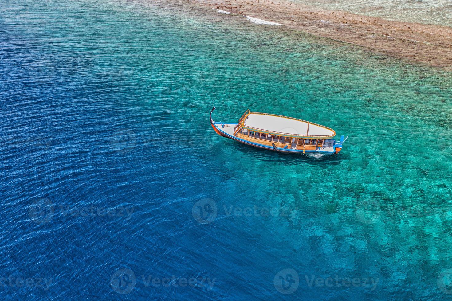 Maldivian exotic diving boat in amazing ocean lagoon over coral ref. Snorkel and outdoor adventure, activity travel landscape concept. Aerial sea view, tranquil nature, luxury travel vacation scenic photo