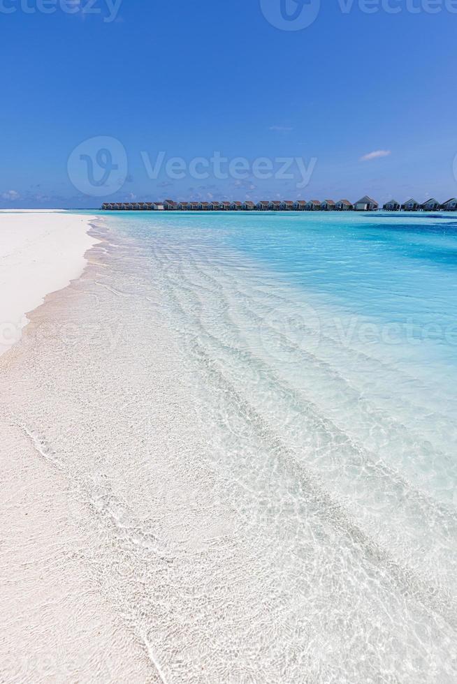 Beautiful panoramic landscape of over water villas, Maldives island, Indian Ocean. Luxury tropical vacation, exotic lagoon, crystal clear water, relaxing blue sky sea. Summer travel tourism paradise photo