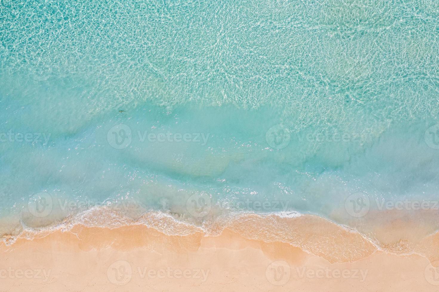 Relaxing aerial beach scene, summer vacation holiday template banner. Waves surf with amazing blue ocean lagoon, sea shore, coastline. Perfect aerial drone top view. Peaceful bright beach, seaside photo