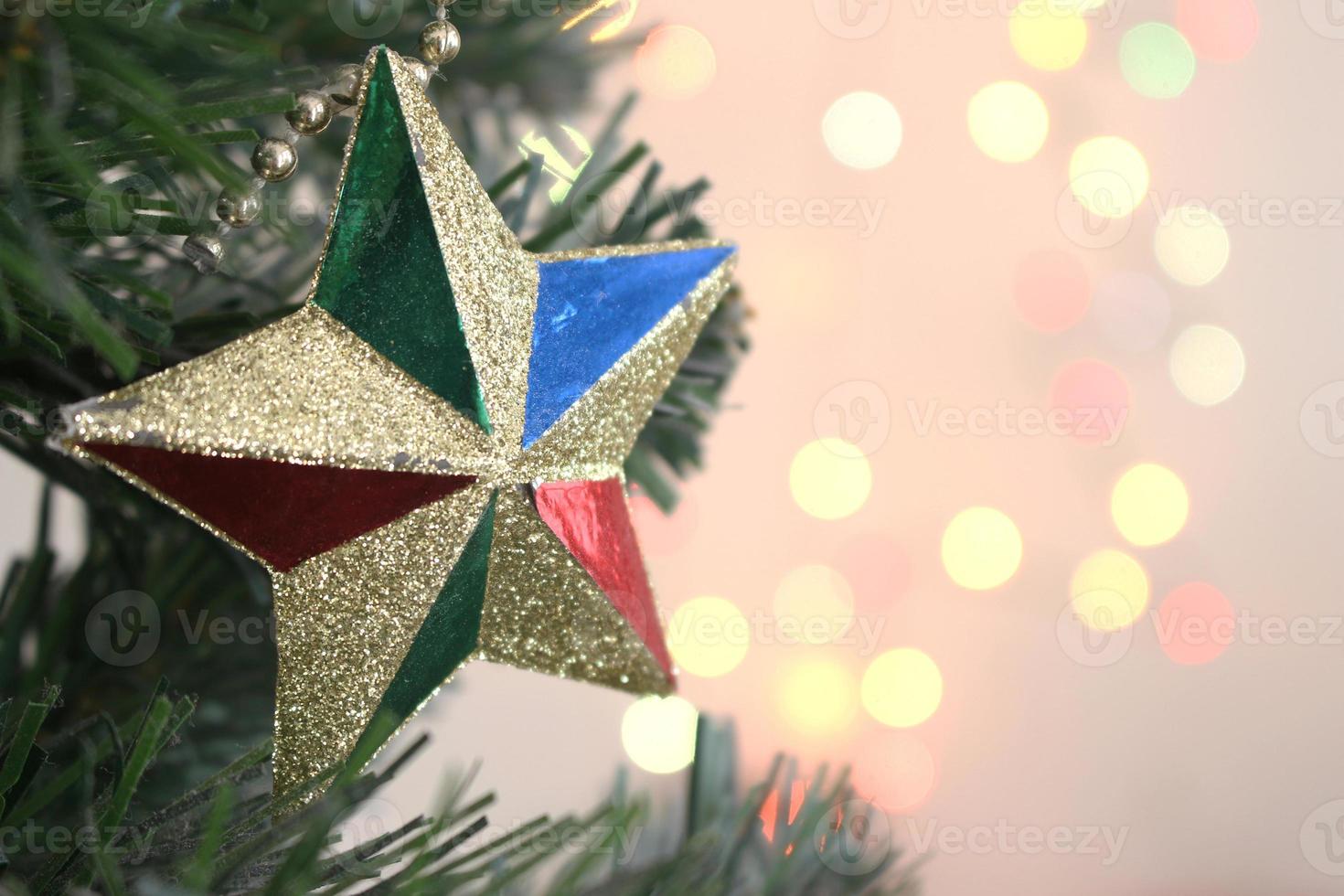christmas tree with decorations gold star with light bokeh background photo