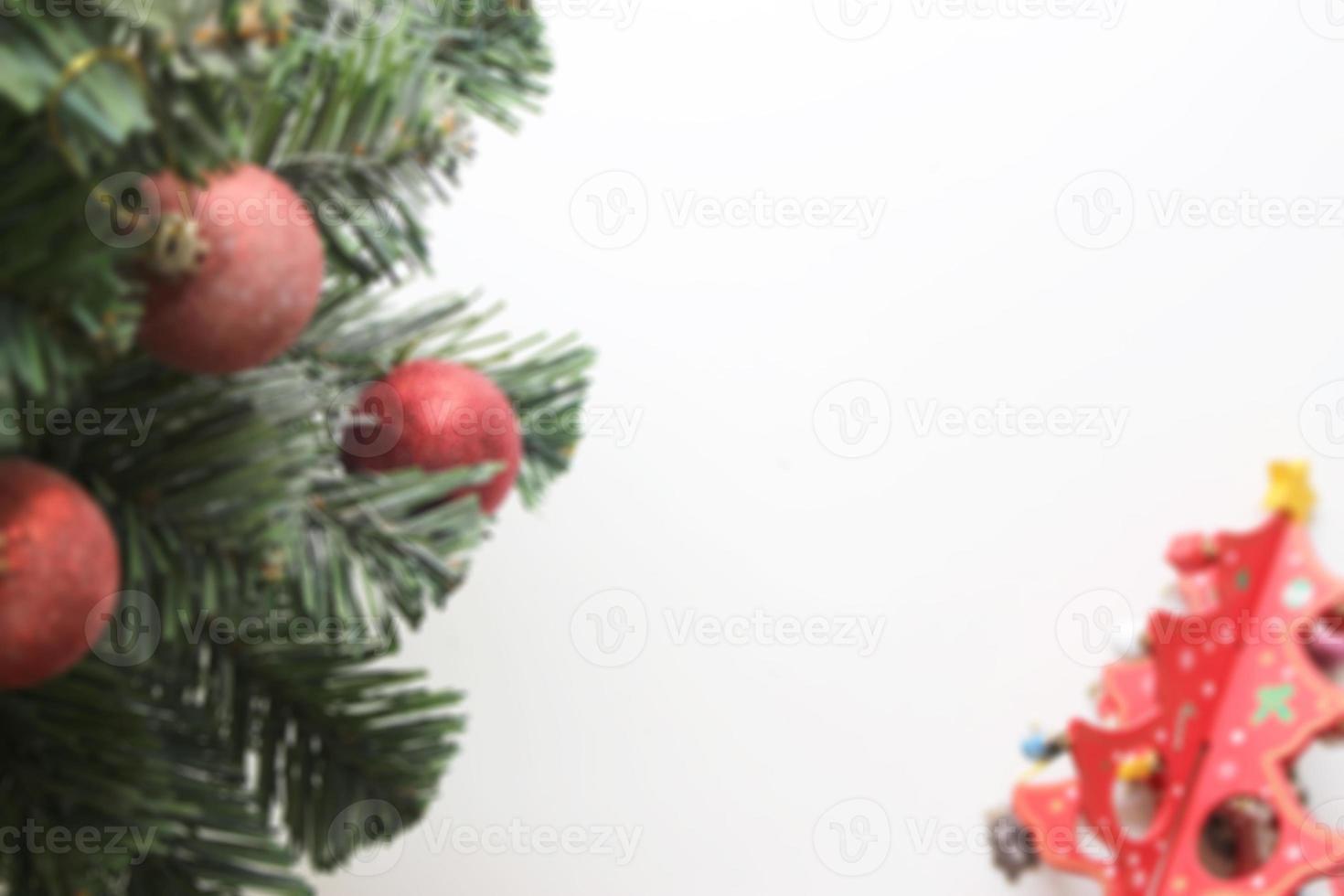 blurred christmas tree with decorations ball on white background photo