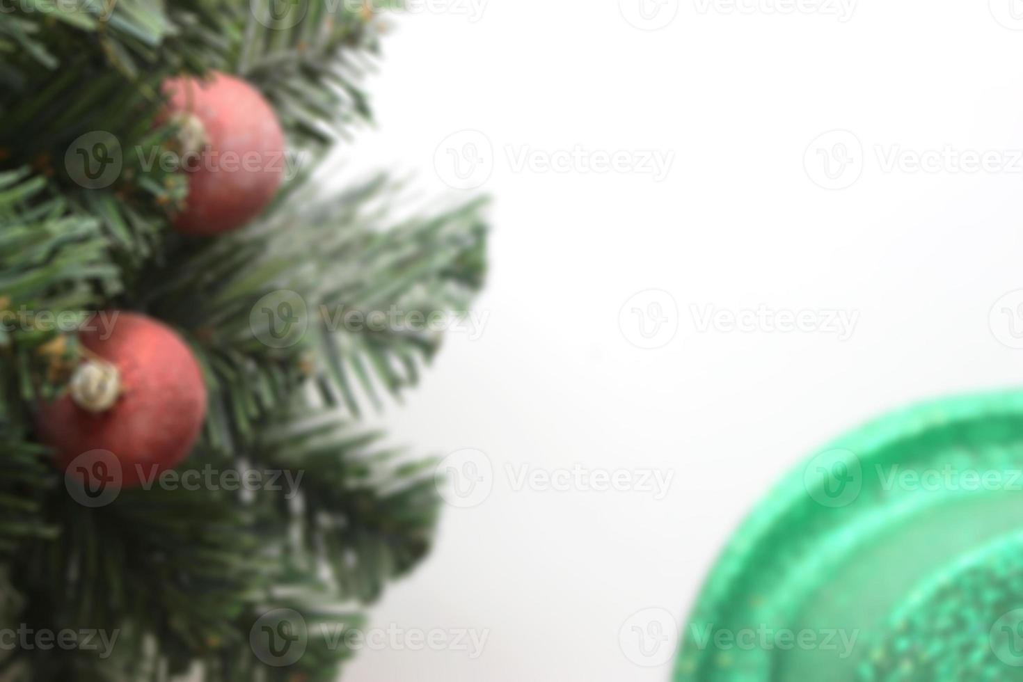 blurred christmas tree with decorations ball on white background photo