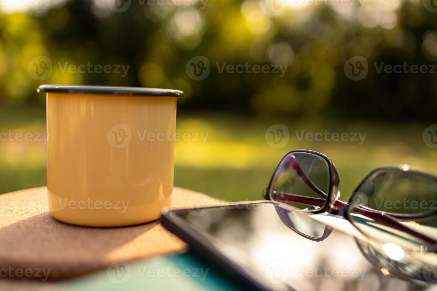 Coffee mugs in the backyard and morning sunshine. photo