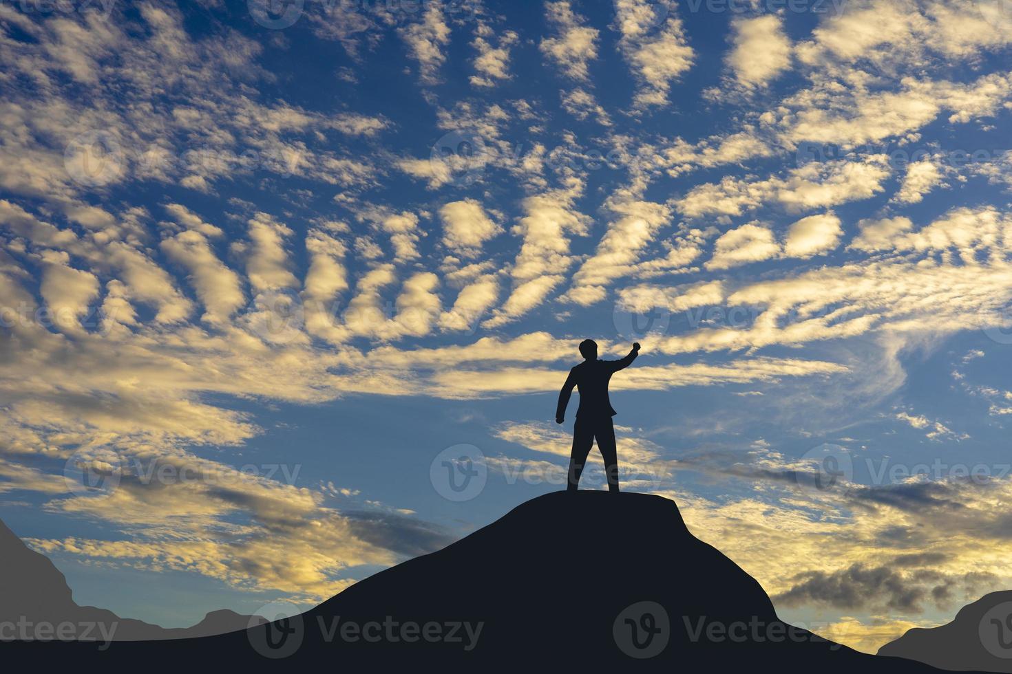 Victory concept, a silhouette of a man standing in the sunset sky. photo